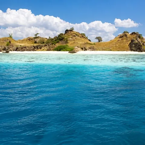 White-sand beach and turquoise shallows at Mawan, Central Komodo
