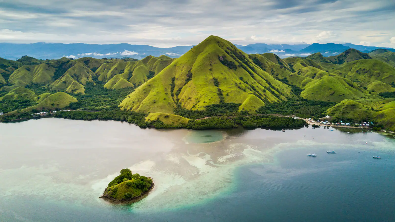 Lush green volcanic hills drone view Komodo archipelago Indonesia