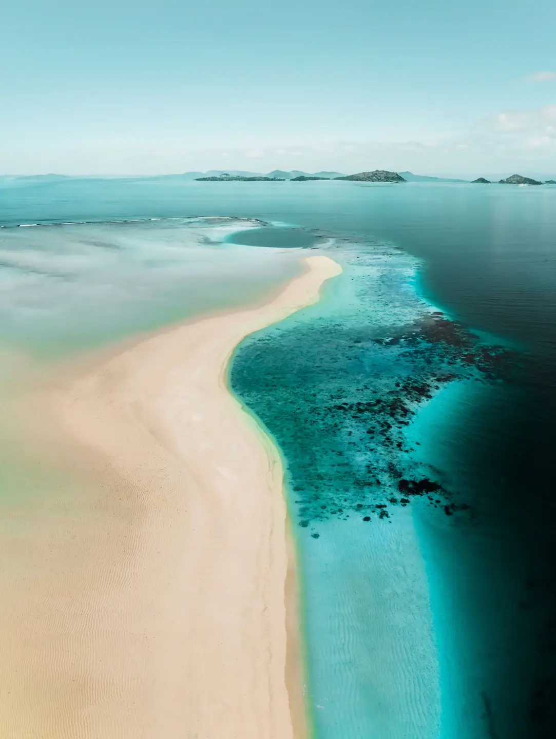 Discover the Top 5 Indonesian Islands Perfect for Private Yacht Adventures Aerial view of pristine Indonesian island perfect for private yacht adventure