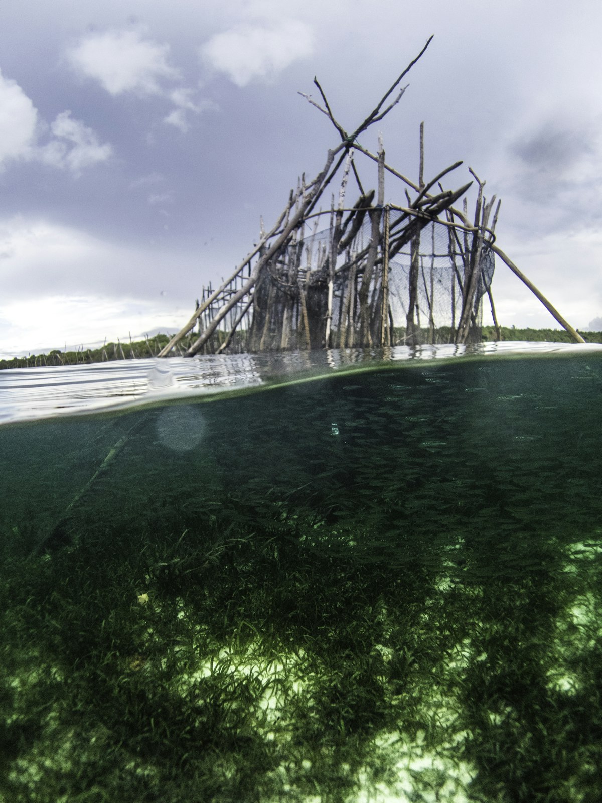Wooden stilt bridge over turquoise sea Bajo village Wakatobi